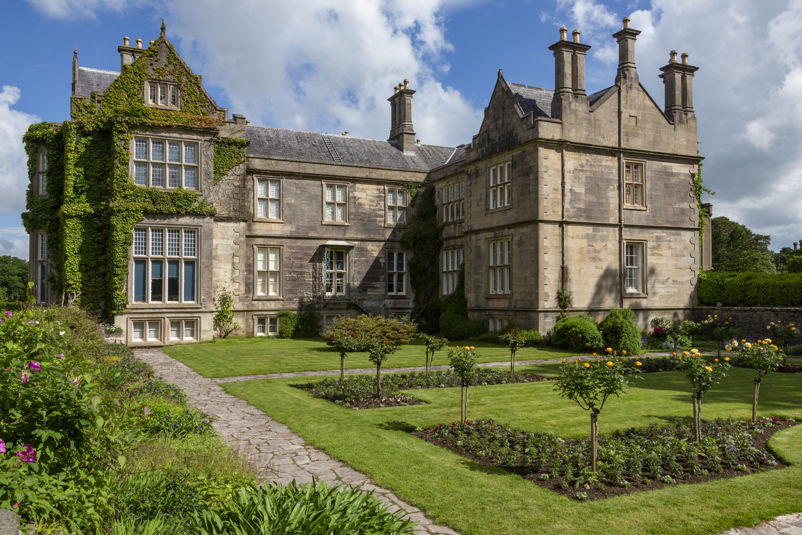 Property valuation of a large historic mansion with extensive gardens, traditional stonework and landscaped grounds.